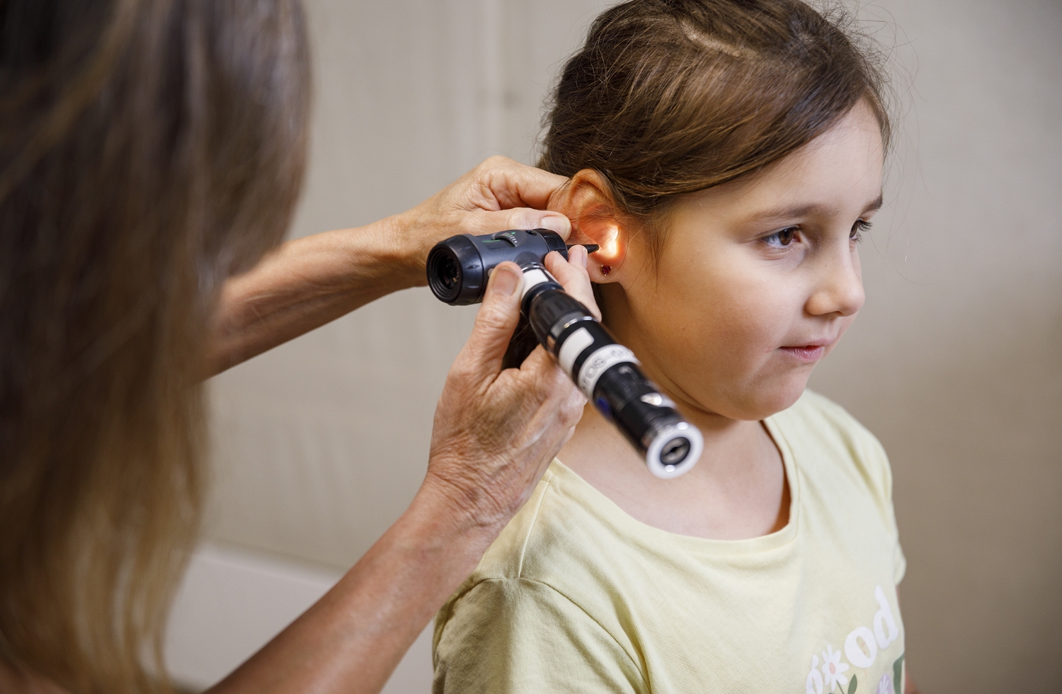 A child having her ears tested for infections.