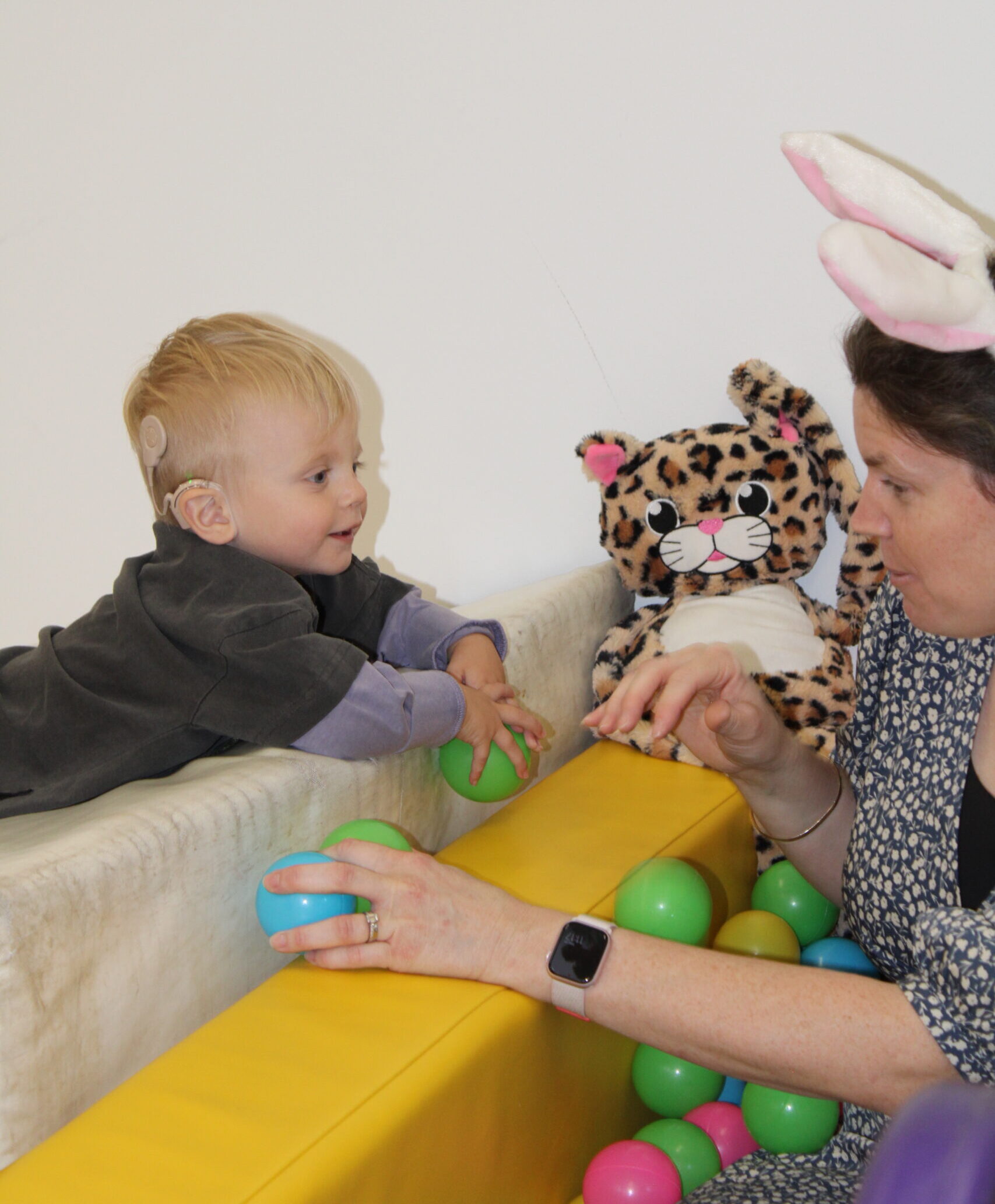 child interacting with adult playing an OT game