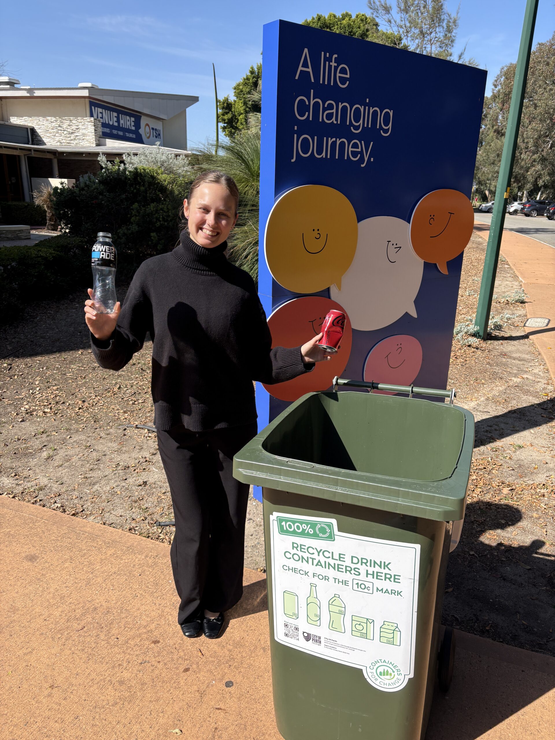 Person standing outside TSH holding containers