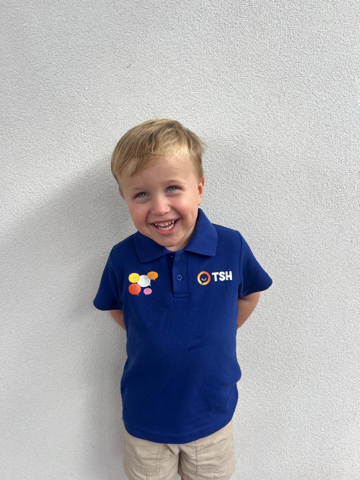 Young boy in blue school uniform